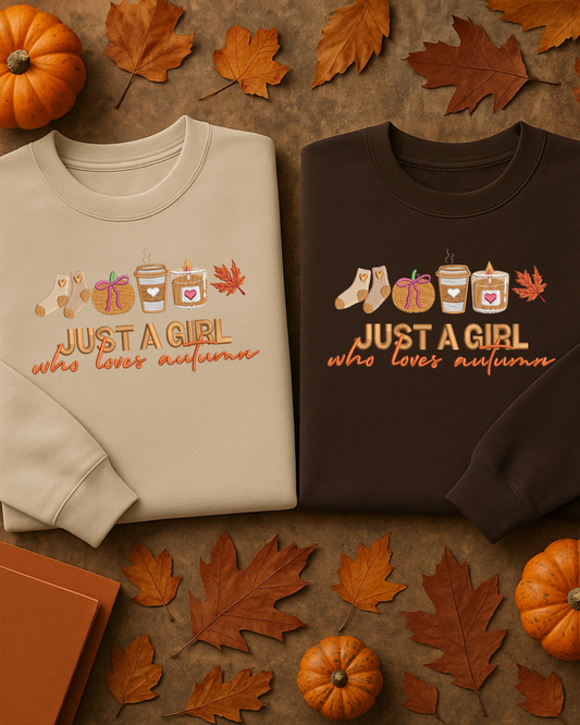 Two sweatshirts with autumn-themed embroidered text and graphics on a brown background with pumpkins and leaves.