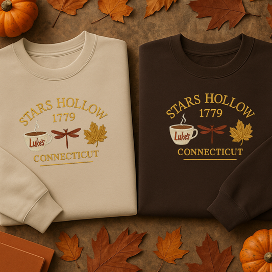 Two sweatshirts with 'Stars Hollow 1779 Luke's Connecticut' design on a brown background with pumpkins and leaves.